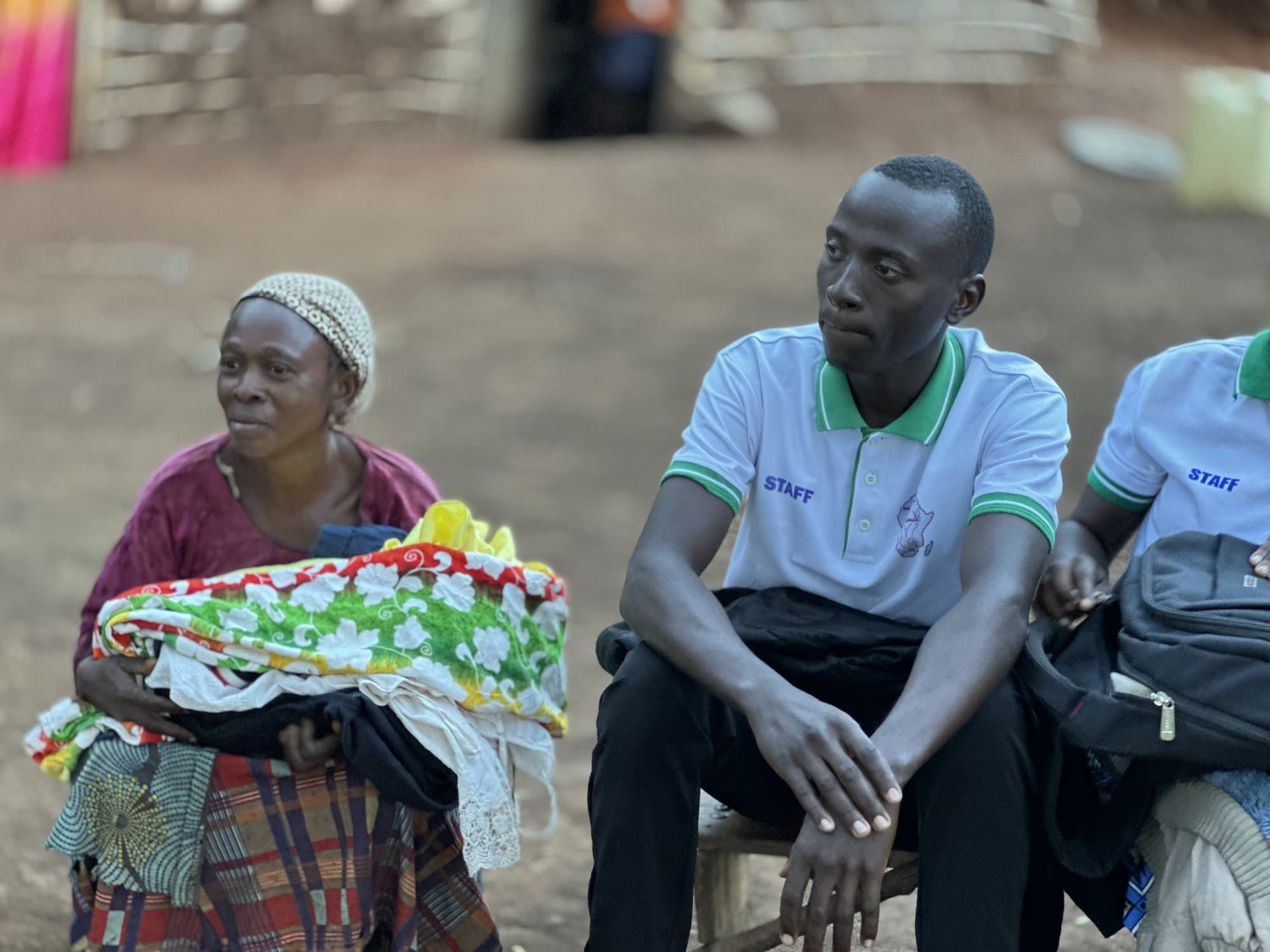 STAC team members handing out clothing to a community member