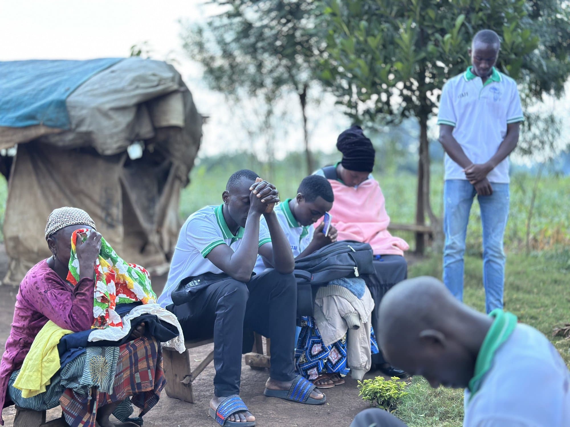 STAC staff praying together with community members